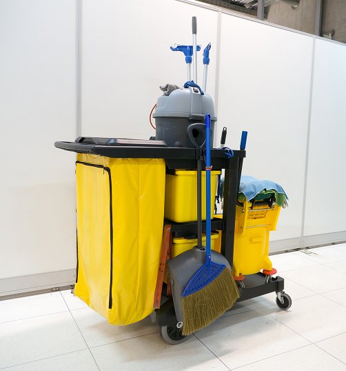 AdobeStock_193818135 1 Yellow commercial cleaning cart equipped with a mop, broom, and bucket for commercial cleaning services.